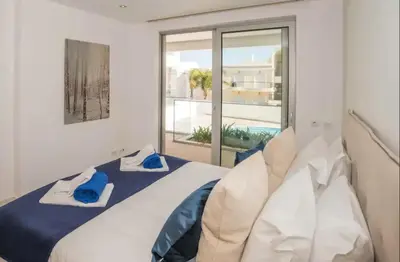 a bedroom with a bed and a large window at ZENTUNI Ocean front in Lagos