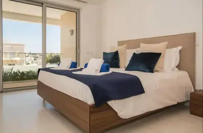 a large bed in a bedroom with a large window at ZENTUNI Ocean front in Lagos