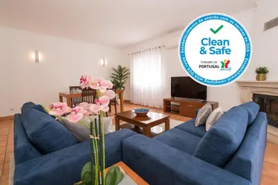 a living room with two blue couches and a fireplace at Two Bedroom Apartment Vila Mos Lagos in Porto de Mós