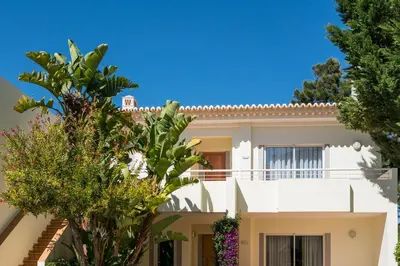 a large white house with trees in front of it at Two Bedroom Apartment Vila Mos Lagos in Porto de Mós