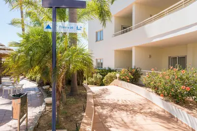 a street sign in front of a building at Two Bedroom Apartment Vila Mos Lagos in Porto de Mós