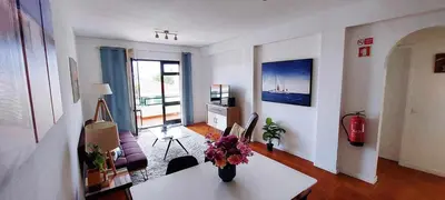 a living room with a vase of flowers on a table at Madeira - Sunset Sea View of Cabo Girão in Funchal