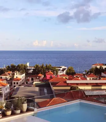 a view of the ocean from the roof of a building at Three House Hotel in Funchal
