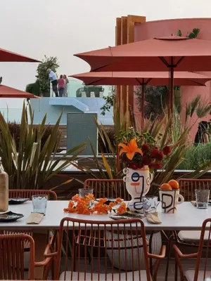 a table with a vase of flowers on it at Three House Hotel in Funchal