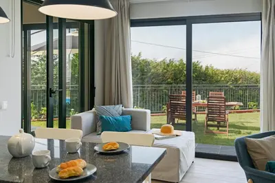a living room with a couch and a table at Vilas Felicidade Rocha by An Island Apart in Ponta do Pargo