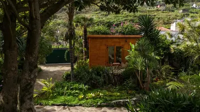 a tiny house in the middle of a garden at Madeira Surf Lodge in São Vicente