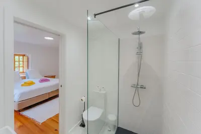 a white bathroom with a sink and a window at Madeira Surf Lodge in São Vicente