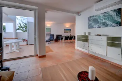 a living room and dining room with a large window at The Fantastic Beach House of Luz in Luz