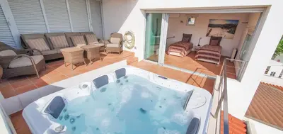 a jacuzzi tub in a living room at The Fantastic Beach House of Luz in Luz