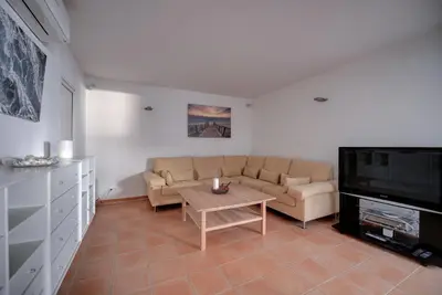 a living room with a couch and a table at The Fantastic Beach House of Luz in Luz