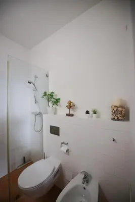a bathroom with a toilet and a sink at The Fantastic Beach House of Luz in Luz