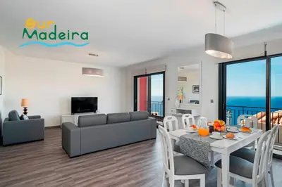 a living room with a table and a couch at OurMadeira - Casa Amaro Sunset in Calheta