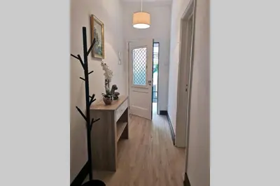 a hallway with a table and a door with a plant at VillaHouse in São Vicente