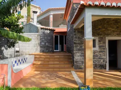 a house with a staircase leading to a house at Vivenda Por do Sol in Ponta do Sol