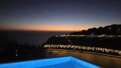 a night view of a swimming pool with lights at Vivenda Por do Sol in Ponta do Sol
