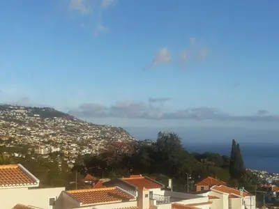 a view of a city with houses and the ocean at Casa do Imaculado in Funchal