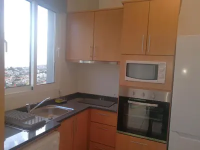 a kitchen with a sink and a microwave at Casa do Imaculado in Funchal