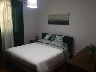 a bedroom with a white bed with two pillows at Casa Vanday in Funchal