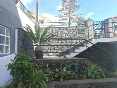 a staircase in a building with plants and flowers at Casa Vanday in Funchal