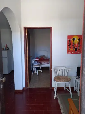 a hallway with a room with a table and chairs at Quintinha das Lombas S in Porto Santo