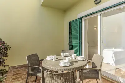 a dining room with a table and chairs at FLH Praia da Luz Apartment with Pool in Alagoas