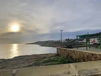 a bus stop next to a body of water at FLH Praia da Luz Apartment with Pool in Alagoas