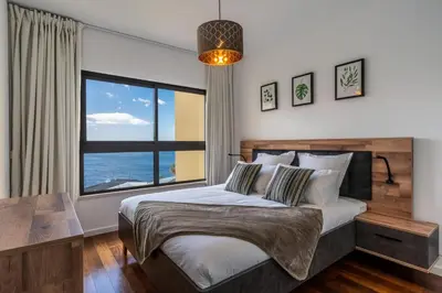 a bedroom with a bed and a large window at Centromar Bella Vista by Atlantic Holiday in Funchal