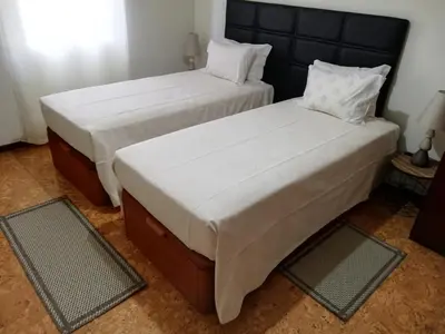 two beds sitting next to each other in a room at House Joel & Sonia with sea view in Funchal