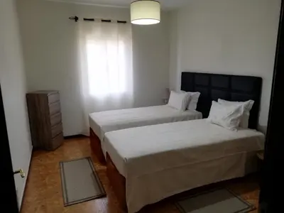 two beds in a small room with a window at House Joel & Sonia with sea view in Funchal