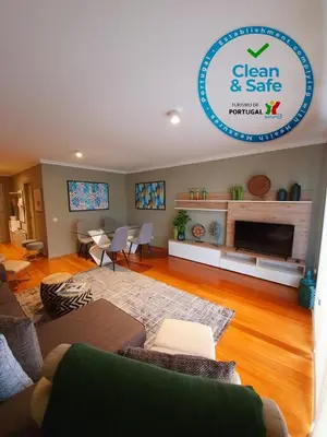 a living room with a couch and a fireplace at Apartamento Boieiro Plaza in Caniço