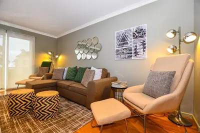 a living room with a couch and two chairs at Apartamento Boieiro Plaza in Caniço