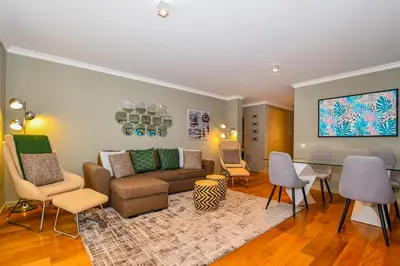 a living room with a couch and chairs and a table at Apartamento Boieiro Plaza in Caniço