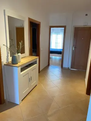 a living room with a counter and a tile floor at St. James Beach & Pool Apartment in Luz
