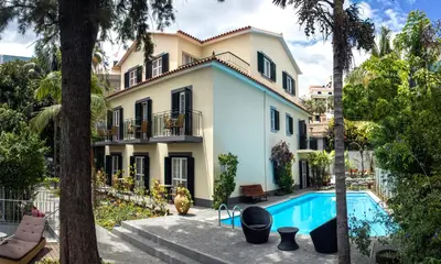 an exterior view of a house with a swimming pool at Vila Vicência in Funchal