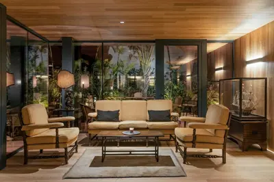 a living room with a couch and two chairs and a table at Vila Vicência in Funchal