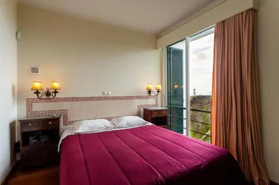 a bedroom with a large bed and a large window at FLH Vivenda Belo Horizonte with Sea View in Caniço