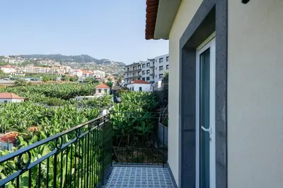 a balcony with a view of a city at Quinta da Saraiva in Câmara de Lobos