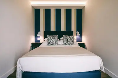 a bedroom with a large bed with two pillows at Quinta da Saraiva in Câmara de Lobos