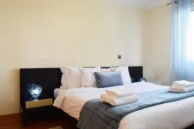 a bedroom with a large bed with towels on it at Perola, a Home in Madeira in Funchal