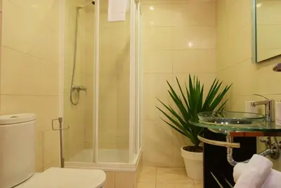 a bathroom with a shower and a toilet and a sink at Perola, a Home in Madeira in Funchal