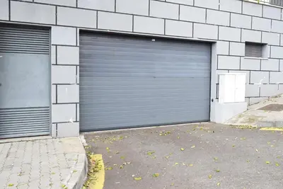 a pair of garage doors on the side of a building at Perola, a Home in Madeira in Funchal