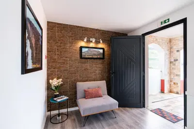 a room with a chair and a brick wall at Roraima House - Private Pool & Garden in Calheta