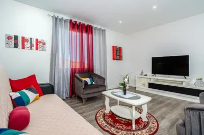 a living room with a couch and a tv at Roraima House - Private Pool & Garden in Calheta