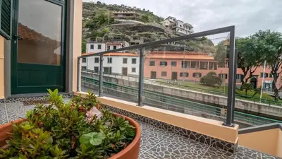 a balcony with a view of a city at Seaside House in Estreito in Estreito da Calheta