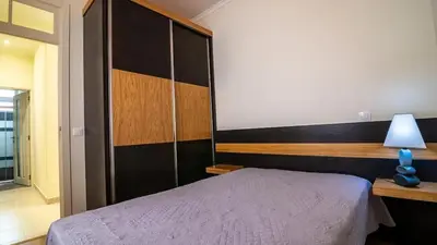 a bedroom with a bed and a large headboard at Seaside House in Estreito in Estreito da Calheta