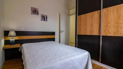 a bedroom with a bed and a table and a lamp at Seaside House in Estreito in Estreito da Calheta
