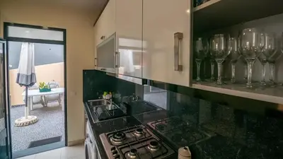 a kitchen with a stove and a counter top at Seaside House in Estreito in Estreito da Calheta