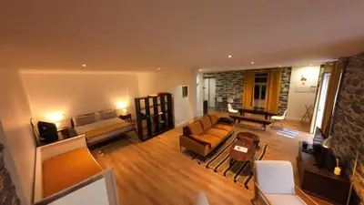 a large living room with a couch and a table at Souza Beach Apartment - Porto da Cruz - Studio & Suite in Porto da Cruz