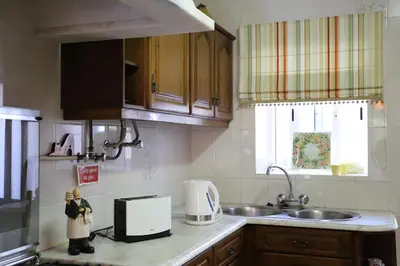 a kitchen with a sink and a counter top at Casa do Quintalão in Raposeira