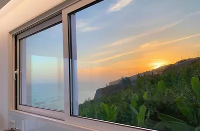 a window with a view of the ocean at Holiday Apartment Ocean View in Ribeira Brava